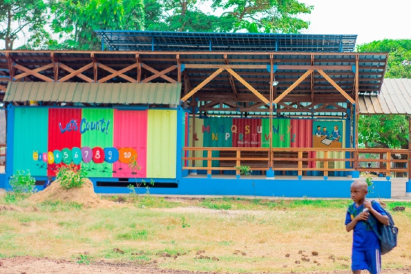 School building with colourful learning mural and solar panels on the roof